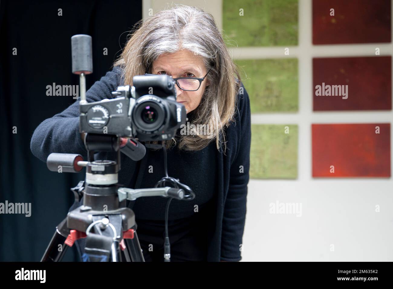 Berlin, Germany. 14th Dec, 2022. Blind photographer Gerald Pirner's visual  assistant Heidi Prenner stands behind a camera. Blindness and photography:  This is not a contradiction, as a photo studio in Berlin shows.