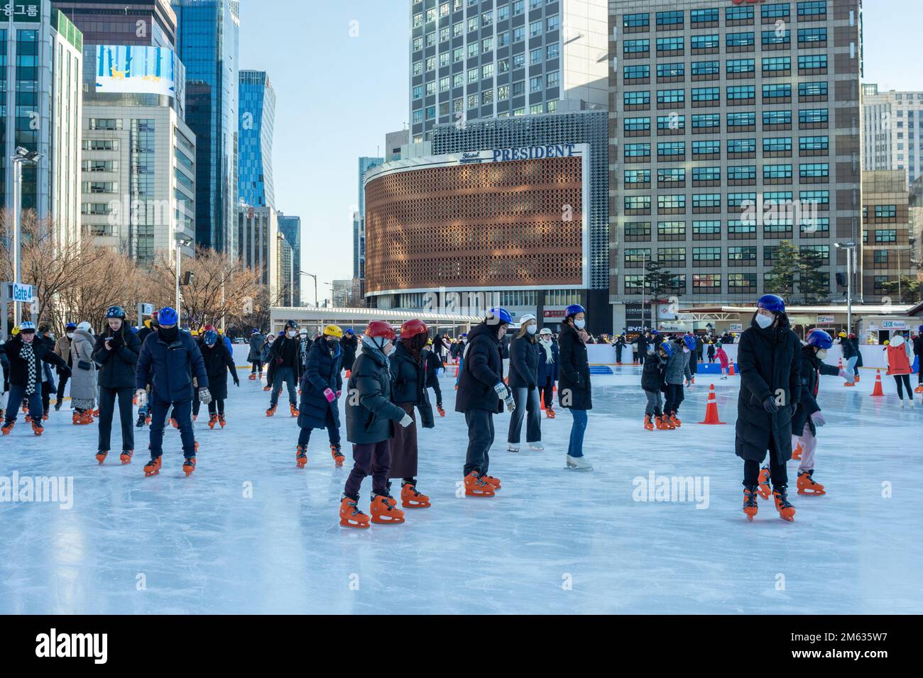 People ice skating on the temporary ice skating ring in front of the