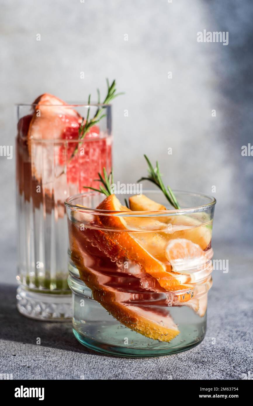 Summer tropical cocktail of vodka and sprite with ripe fruits and
