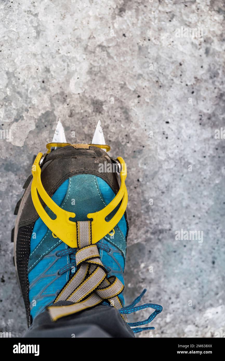 Top view of crop anonymous persons foot in blue mountaineering boot