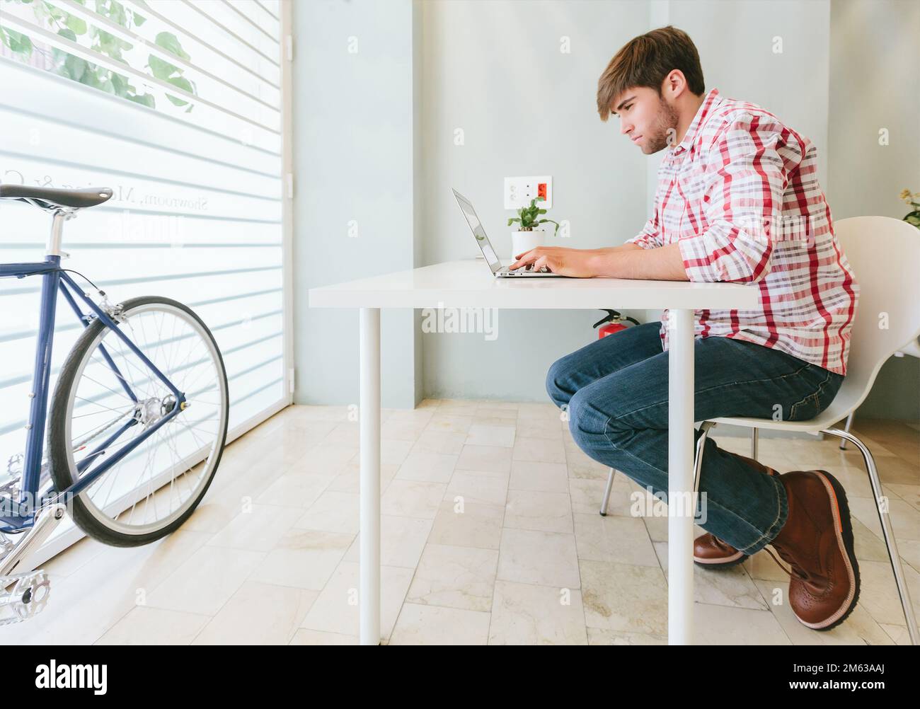 Young Man Working at the Office with a laptop Stock Photo