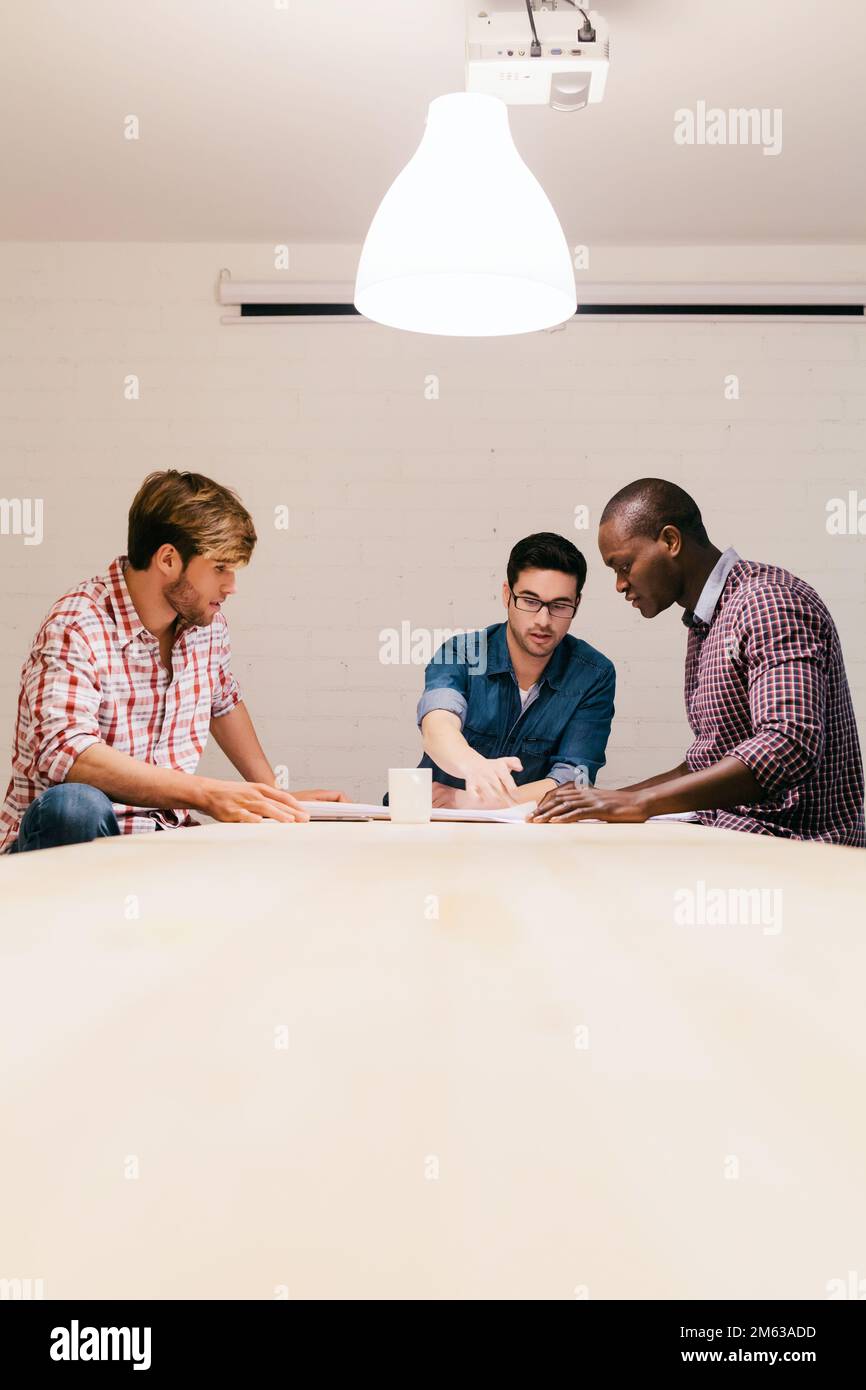 Three Architects and engineers working at the Office Stock Photo