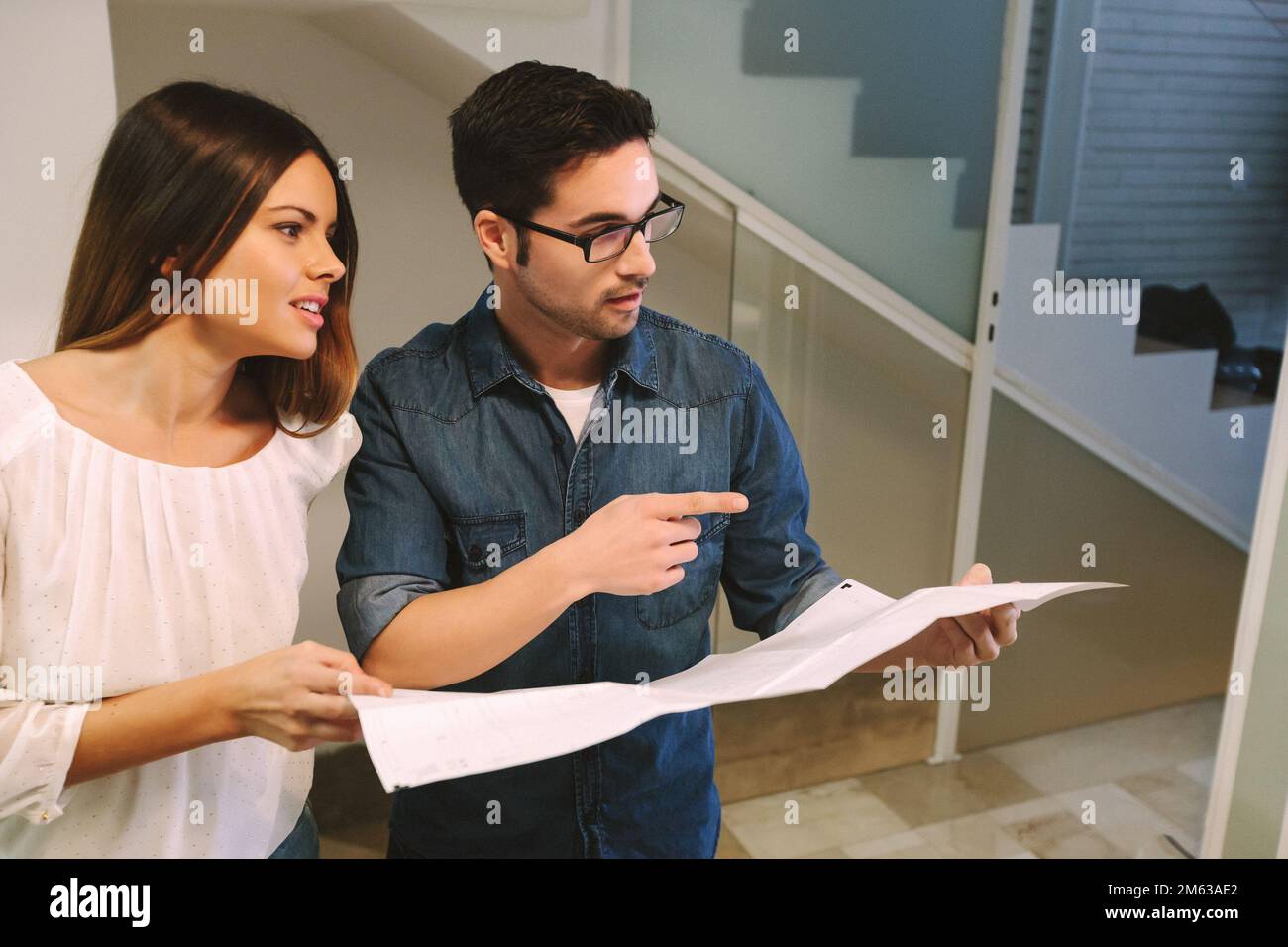 Two architects and engineers working at the Office and looking a blueprints Stock Photo