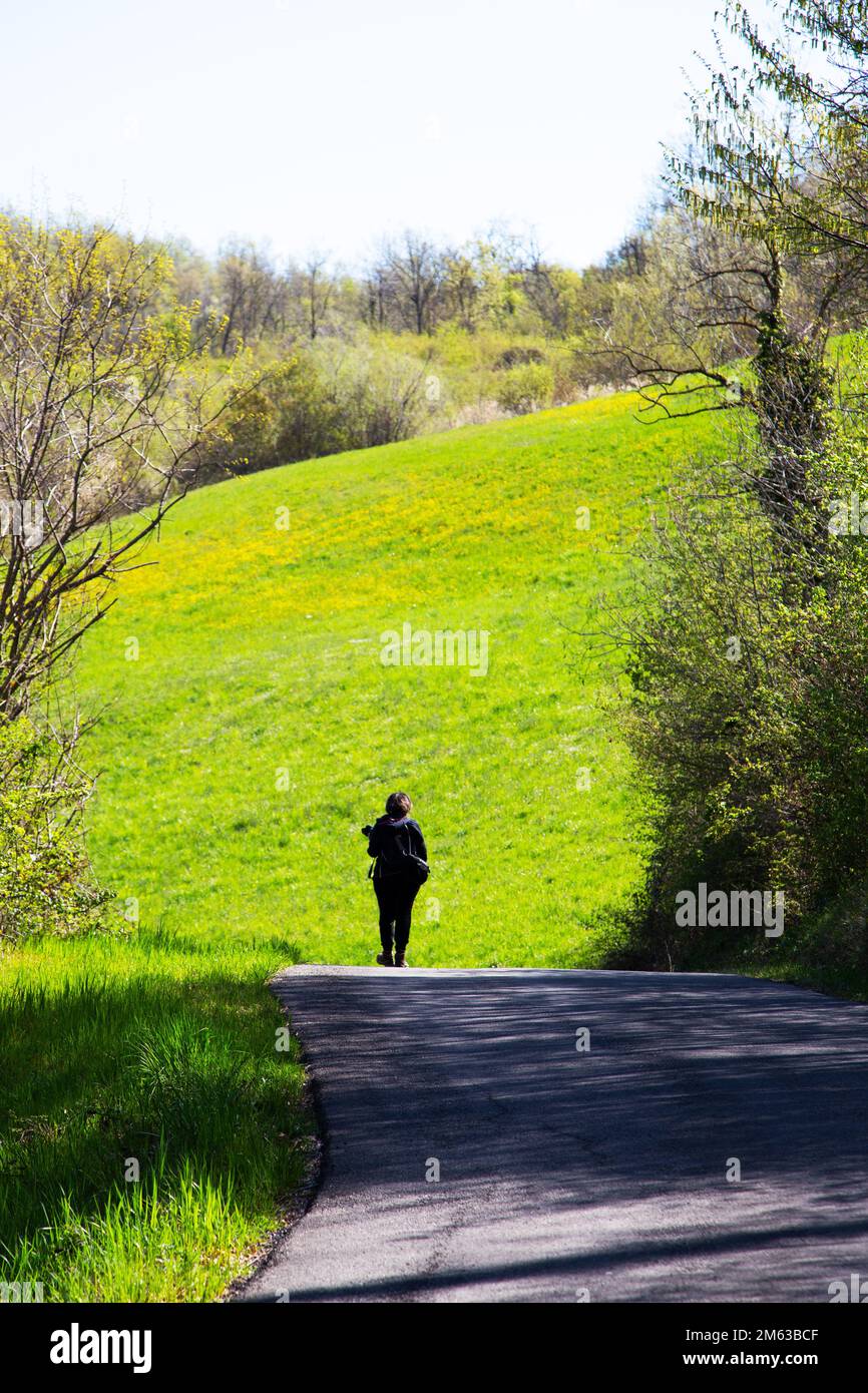 Woman walking on the old hillside path Stock Photo