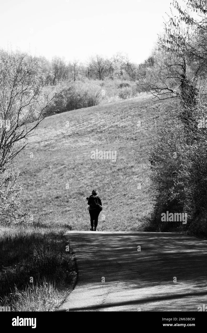 Woman walking on the old hillside path Stock Photo