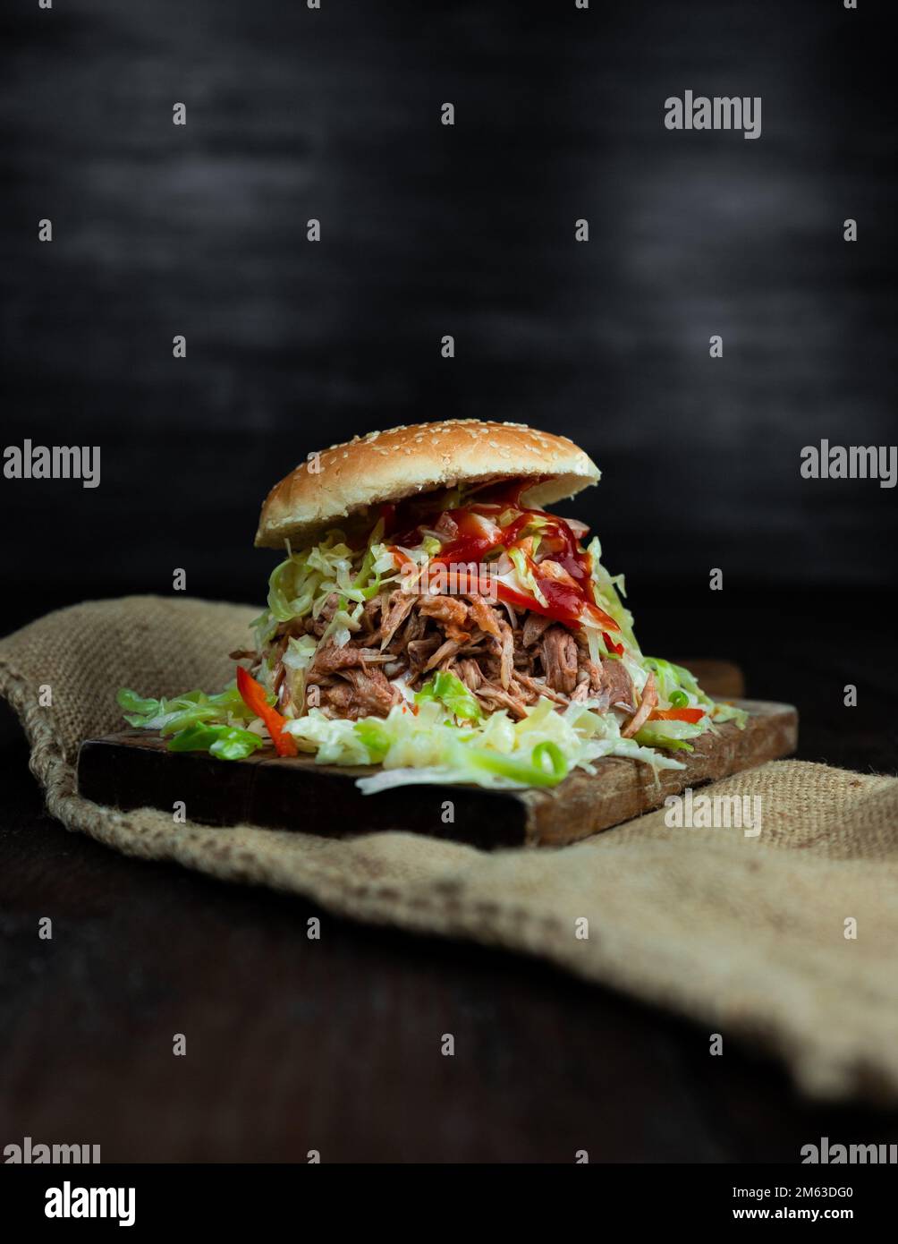 Pulled pork sandwich with coleslaw, buns and seasoning. Pulled pork burgers. Stock Photo