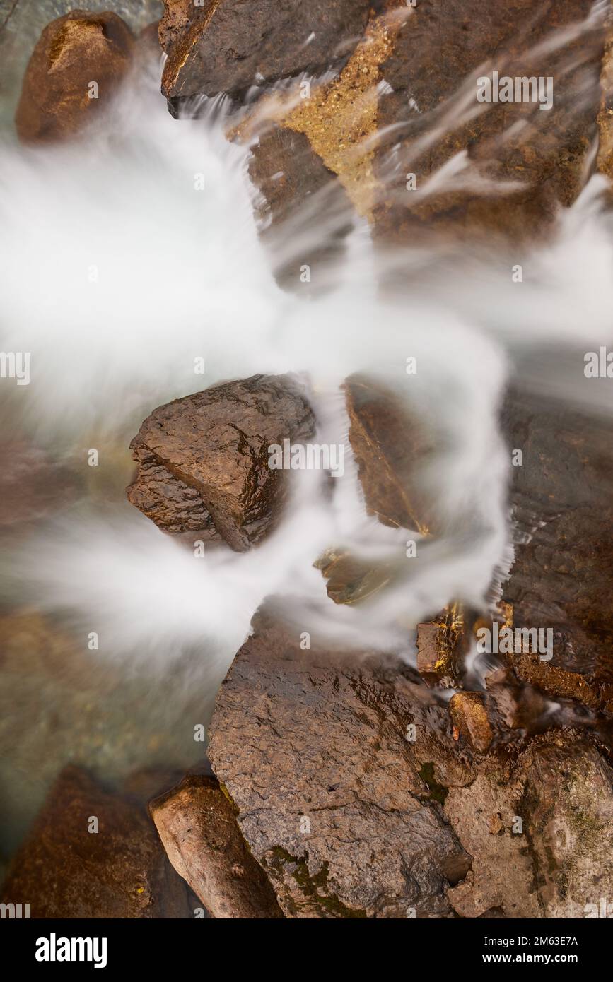 Large rocks in a river in Switzerland nature Stock Photo - Alamy