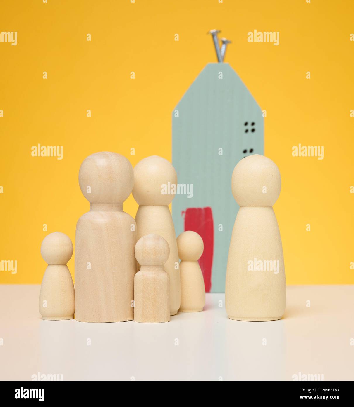 Miniature figurines of family on white background stock photo