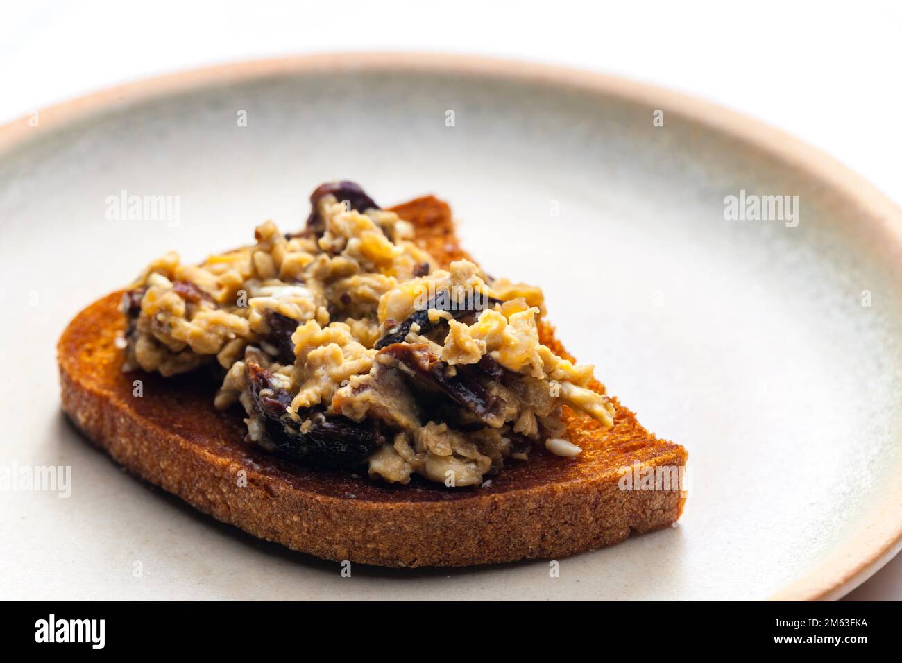 roasted bread served with scrambled eggs and mushrooms Stock Photo - Alamy