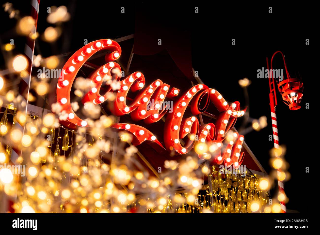 Belgrade, Serbia - December 23, 2022: Coca Cola logo at exhibition stand in the streets of Belgrade on Christmas holidays in the night. Stock Photo