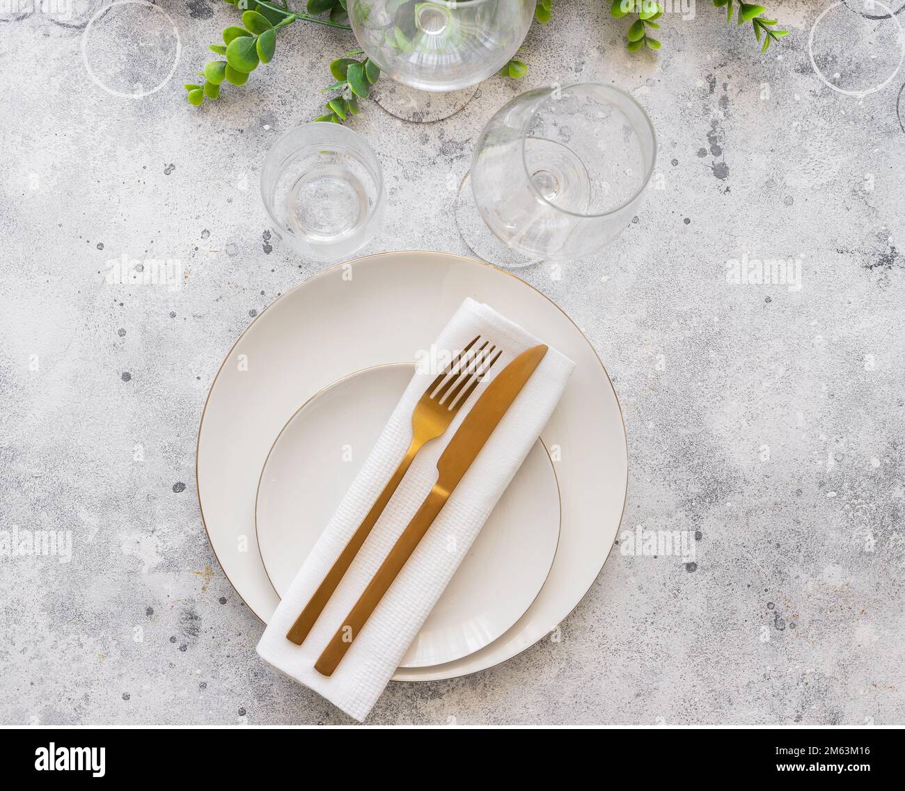 Table setting with textured wine glasses, candles and leaves. Stock Photo  by puhimec