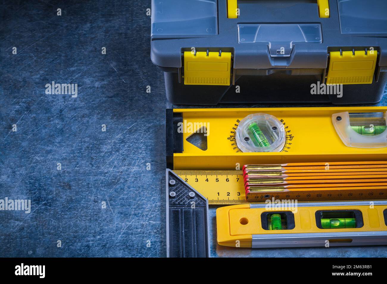 Toolbox construction level wooden meter square ruler and tin snips on ...