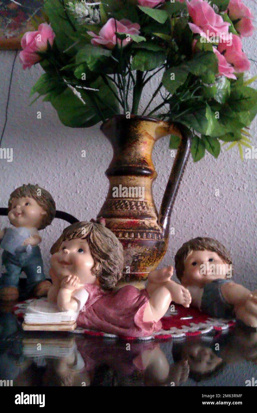figures of naughty children at the foot of the vase. Stock Photo