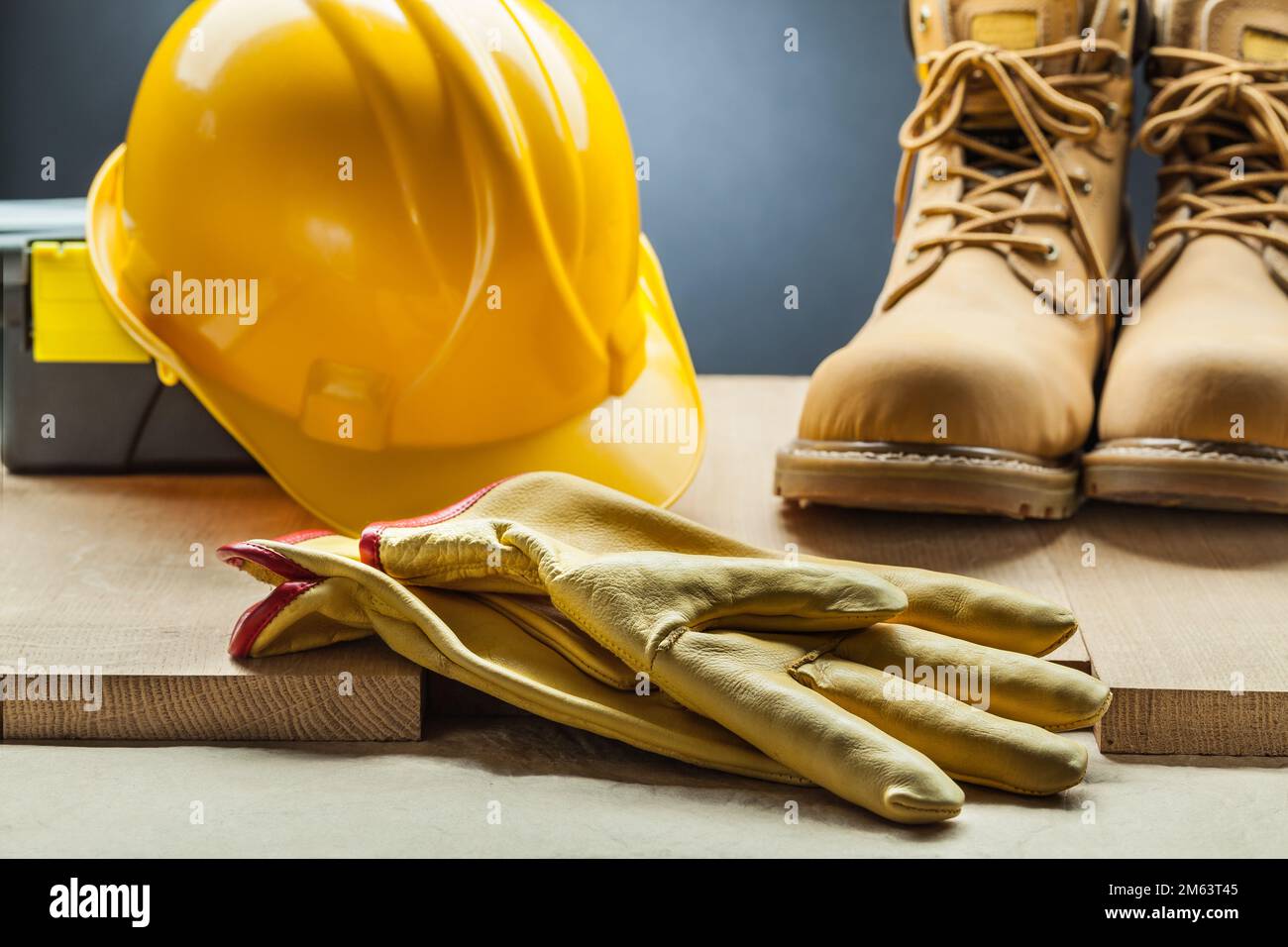 yellow leather gloves working boots construction helmet toolbox Stock Photo