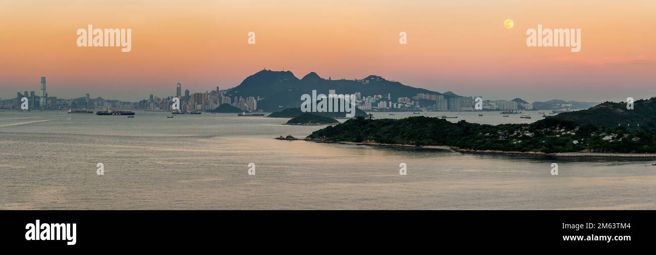 Hi-res panorama of the full moon rising above Cyberport, with Victoria Peak and the city skyline of Hong Kong at dusk, 2012 (156Mpx) Stock Photo