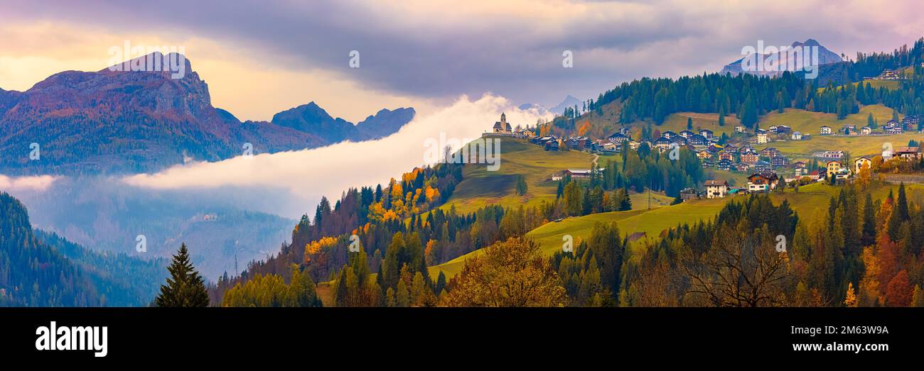 A wide 3:1 panorama image with autumn colors in Colle Santa Lucia, a village and comune in the Italian province of Belluno, in the Veneto region. The Stock Photo