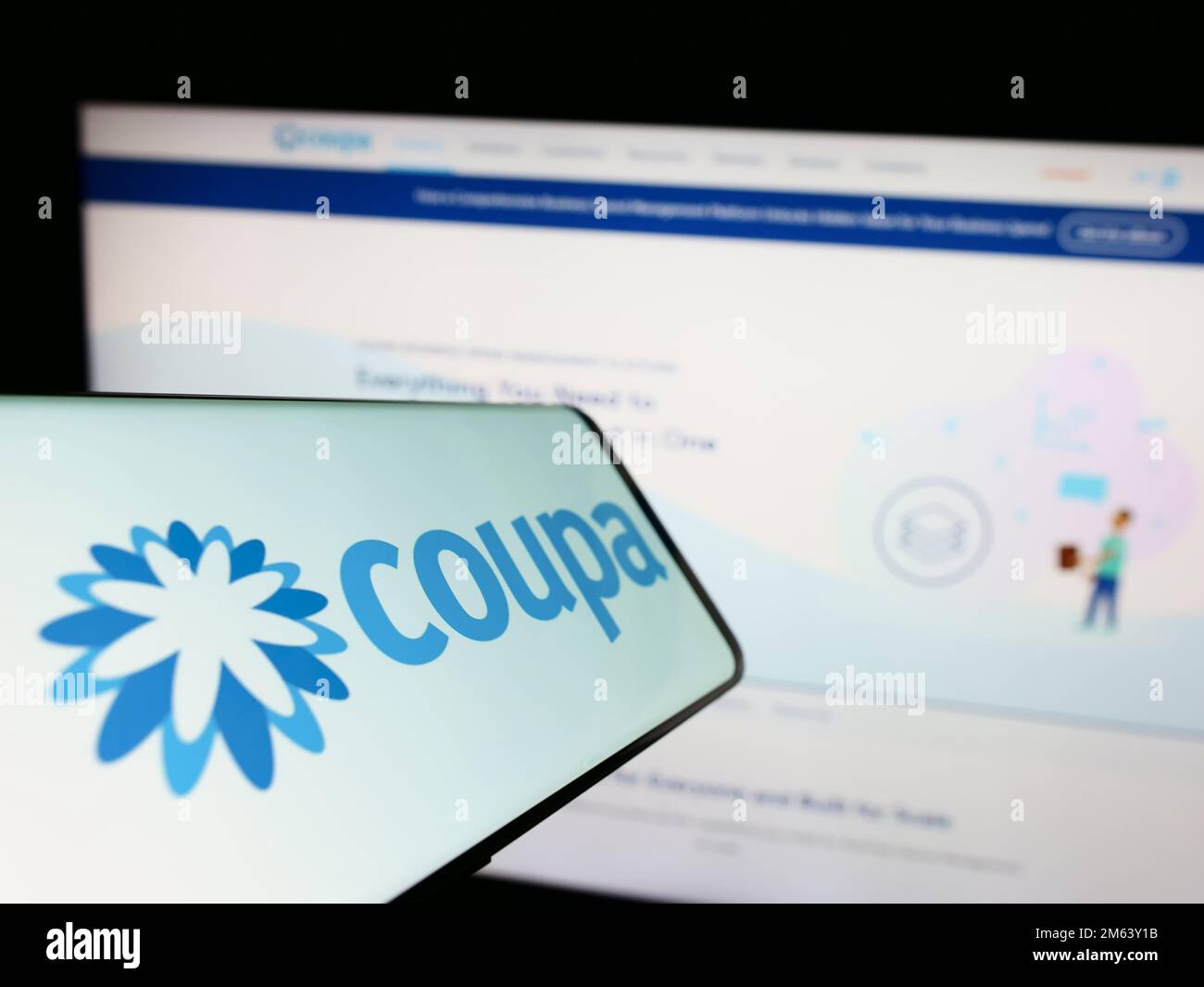 Mobile phone with logo of spend management company Coupa Software Inc. on screen in front of business website. Focus on center of phone display. Stock Photo