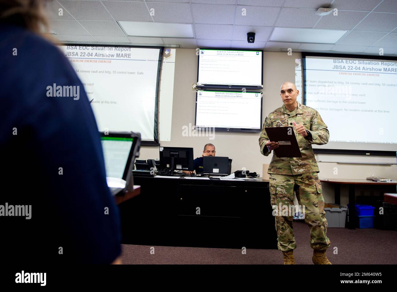U.S. Lt. Col. Clemente Berrios (right), Emergency Operations Center director and 902nd Civil Engineer Squadron commander, addresses staff of the Crisis Action Team during a Major Accident Response Exercise, Mar. 30, 2022, at Joint Base San Antonio-Randolph, Texas. MAREs demonstrate JBSA’s Disaster Response Forces ability to assess and respond to an aircraft mishap. The 502nd Air Base Wing worked alongside the Schertz Fire Department, 12th Flying Training Wing and the 59th Medical Wing validate the necessary support during a simulated accident. Stock Photo