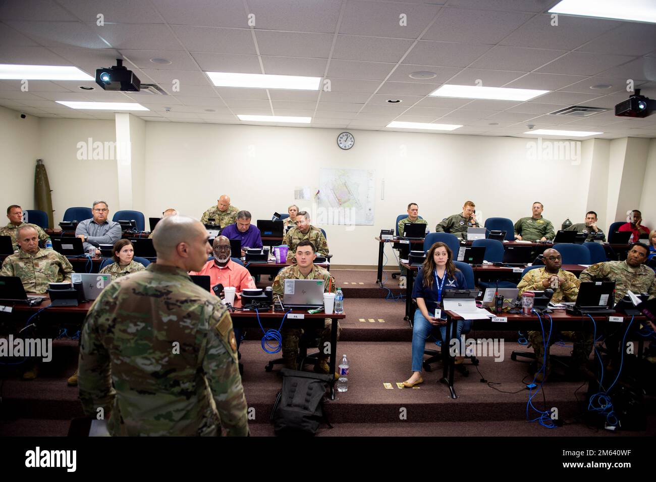 U.S. Lt. Col. Clemente Berrios (left front), Emergency Operations Center director and 902nd Civil Engineer Squadron commander, addresses staff of the Crisis Action Team during a Major Accident Response Exercise, Mar. 30, 2022, at Joint Base San Antonio-Randolph, Texas. MAREs demonstrate JBSA’s Disaster Response Forces ability to assess and respond to an aircraft mishap. The 502nd Air Base Wing worked alongside the Schertz Fire Department, 12th Flying Training Wing and the 59th Medical Wing validate the necessary support during a simulated accident. Stock Photo