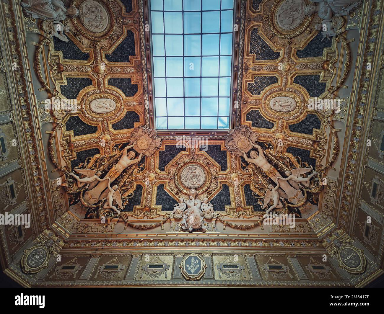 Golden ceiling with architectural details of the Salon Carre inside ...