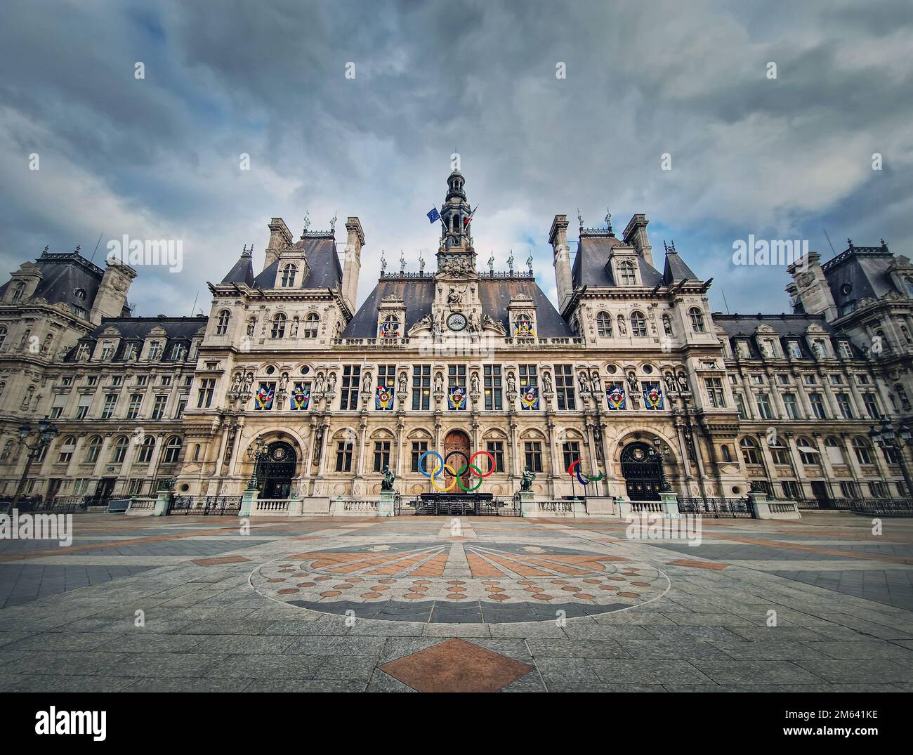 Paris City Hall, France. Outdoors view to the beautiful ornate facade of the historical building and the olympic games rings symbol in front of the ce Stock Photo