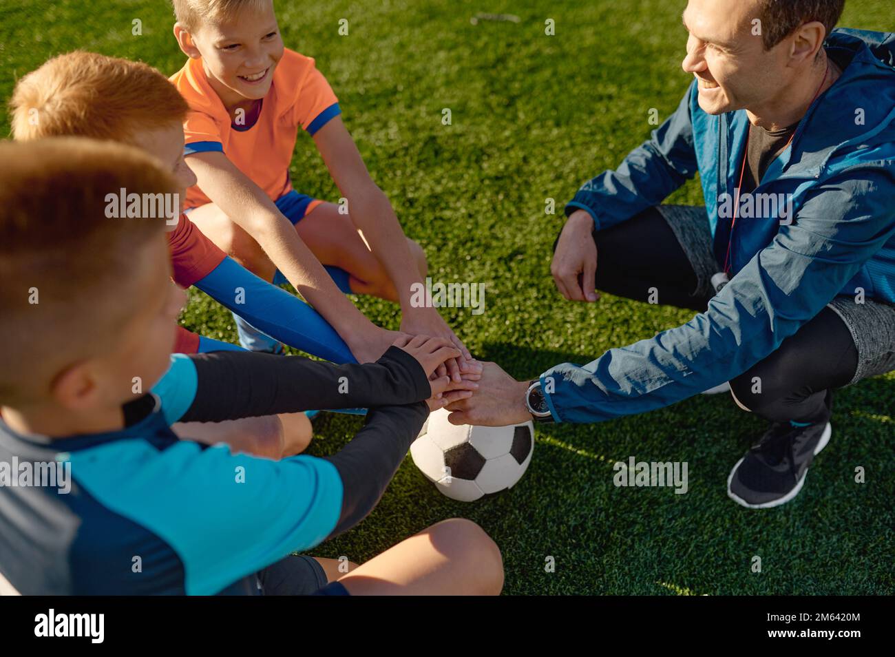 Football coach motivating junior soccer team before match Stock Photo