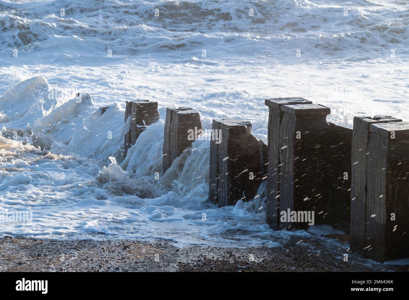 Wooden beach groyne, waves and spray, Bexhill-on-Sea, England Stock Photo