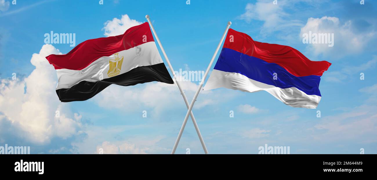 two crossed flags Republic Srpska and Egypt waving in wind at cloudy ...