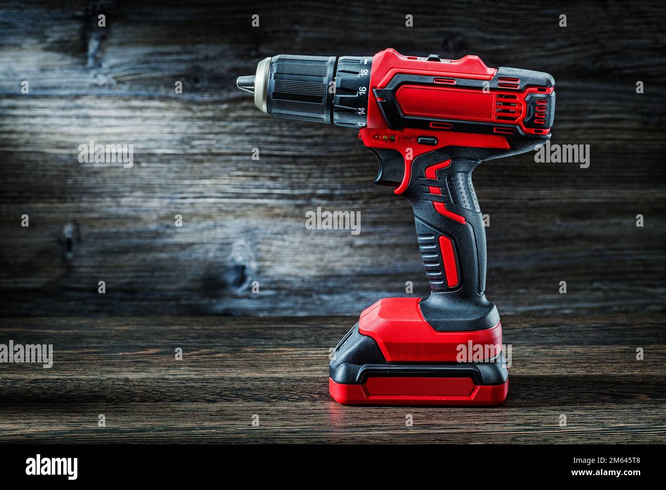 https://c8.alamy.com/comp/2M645T8/red-cordless-drill-driver-electric-screwdriver-on-vintage-wood-background-2M645T8.jpg