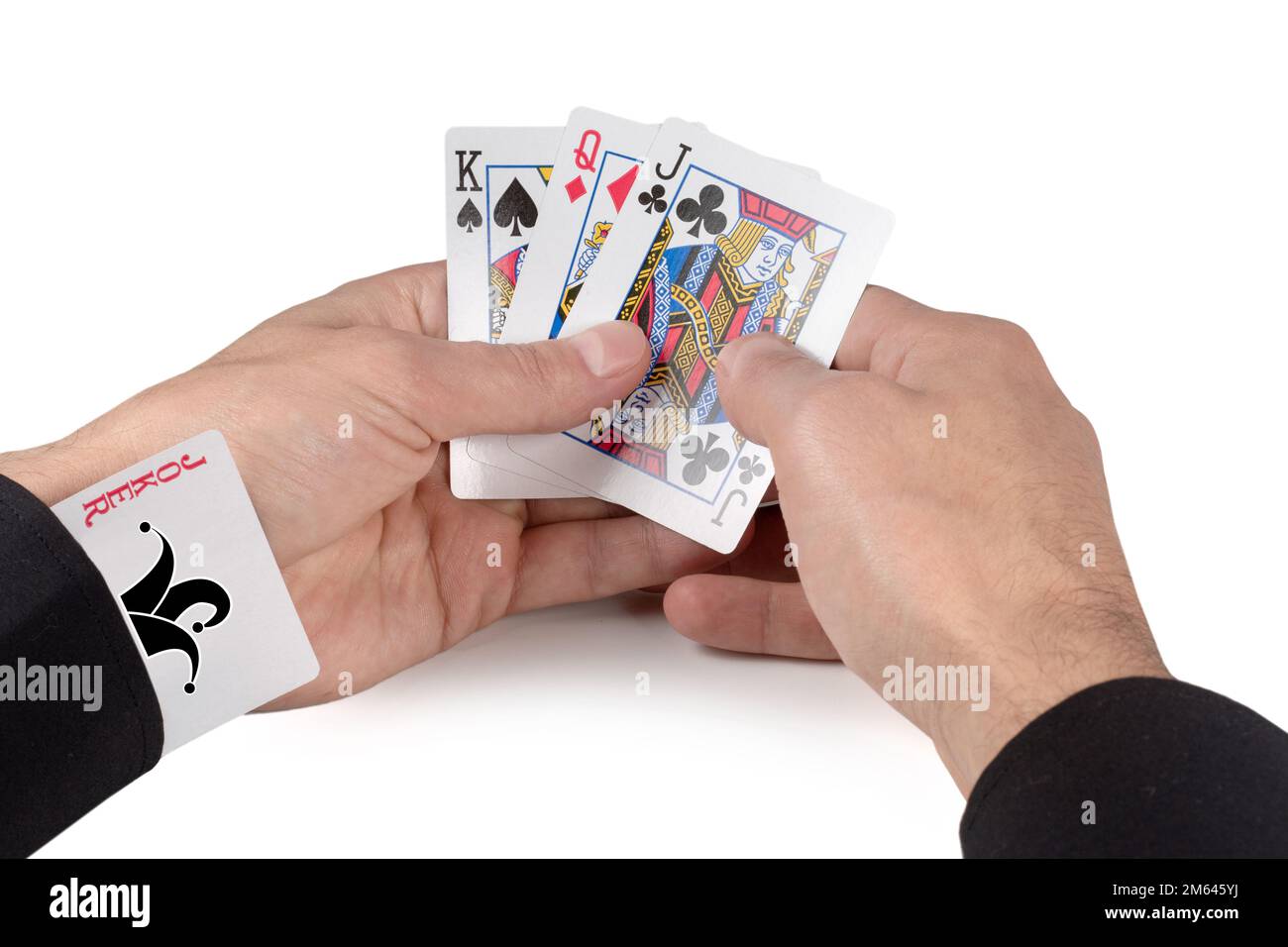 Concept - joker card in the sleeve. A man holding cards in his hands on ...
