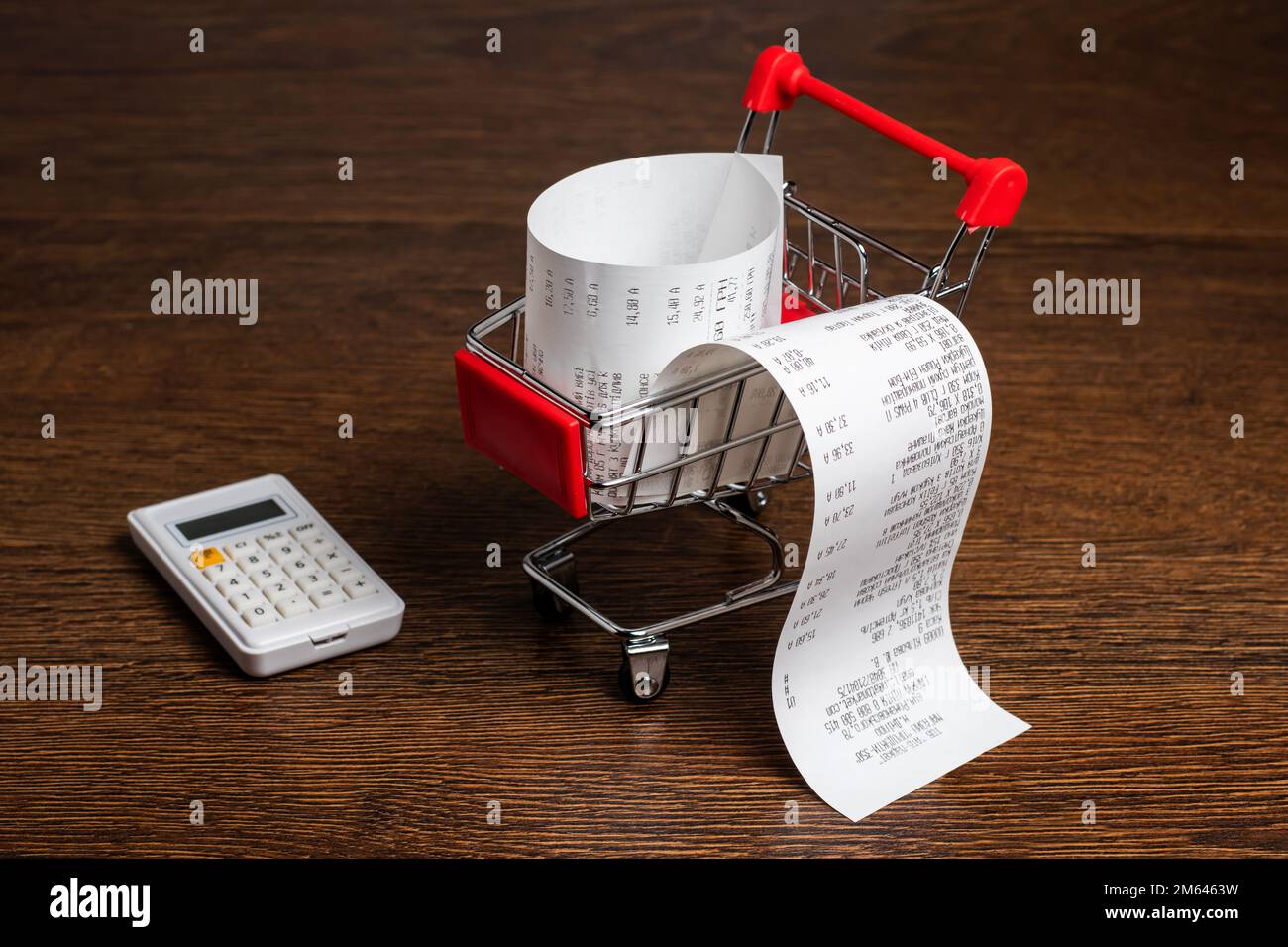 Shopping cart with receipt and calculator. Concept for grocery expenses