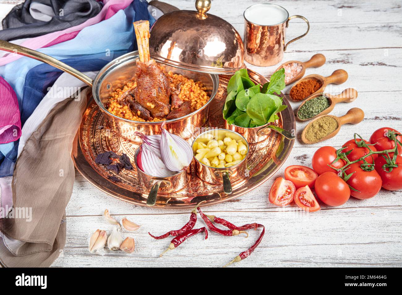 Presentation of traditional Turkish meat dishes. Turkish foods; lamb shank tandoori on bulgur wheat rice (Turkish name; bulgur bugday pilavi kuzu inci Stock Photo