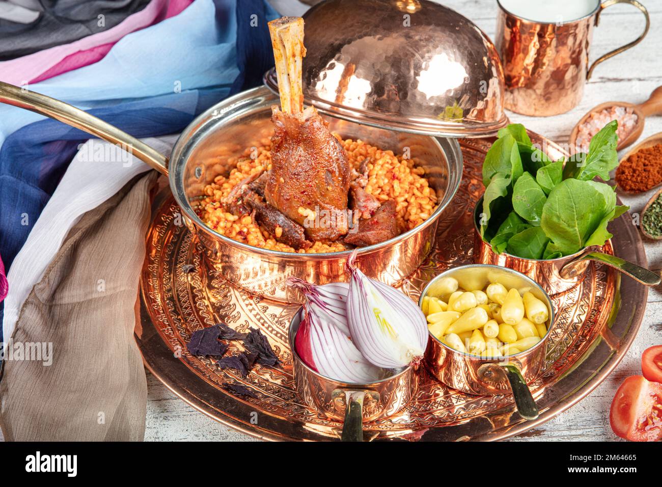 Presentation of traditional Turkish meat dishes. Turkish foods; lamb shank tandoori on bulgur wheat rice (Turkish name; bulgur bugday pilavi kuzu inci Stock Photo