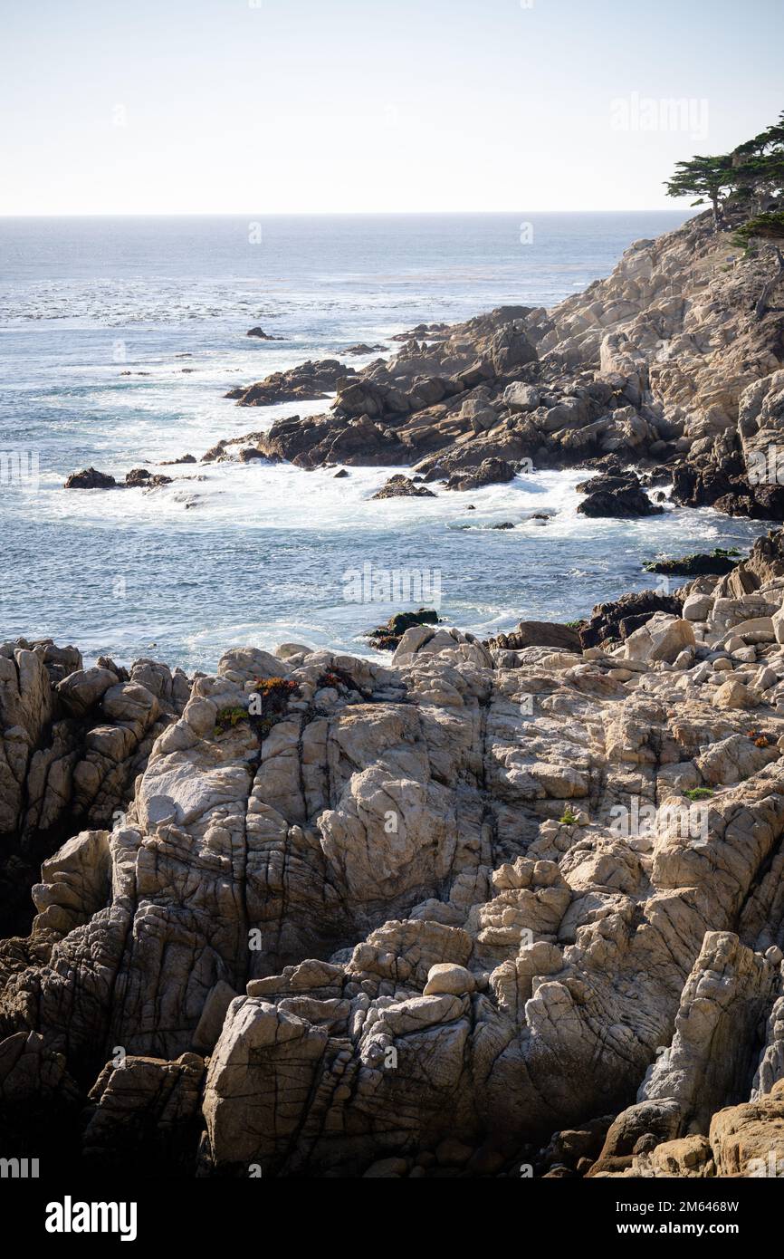 A vertical shot of rocky cliffs on the beach Stock Photo - Alamy