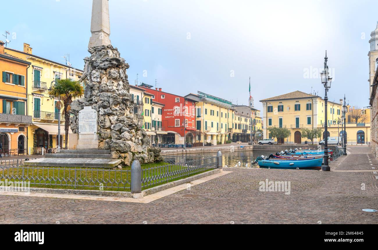 Old harbor of the small and picturesque town of Lazise on Lake Garda in the winter season. Lazise, Verona province, northern Italy,Europe Stock Photo