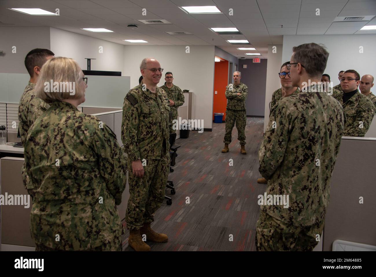220330-N-XK809-1038 FORT GEORGE G. MEADE, Md. (March 30, 2022) Rear Adm. Stephen Donald, right, Vice Commander, U.S. Fleet Cyber Command / U.S. 10th Fleet, speaks to U.S. Navy Reserve Sailors during Operation Cyber Dragon. During Operation Cyber Dragon, conducted Mar. 7 - Apr. 1, Reserve Sailors assigned U.S. Fleet Cyber Command/U.S. 10th Fleet, conducted scanning of the Navy's unclassified network to identify, remediate and implement corrective actions to reduce vulnerabilities. Stock Photo