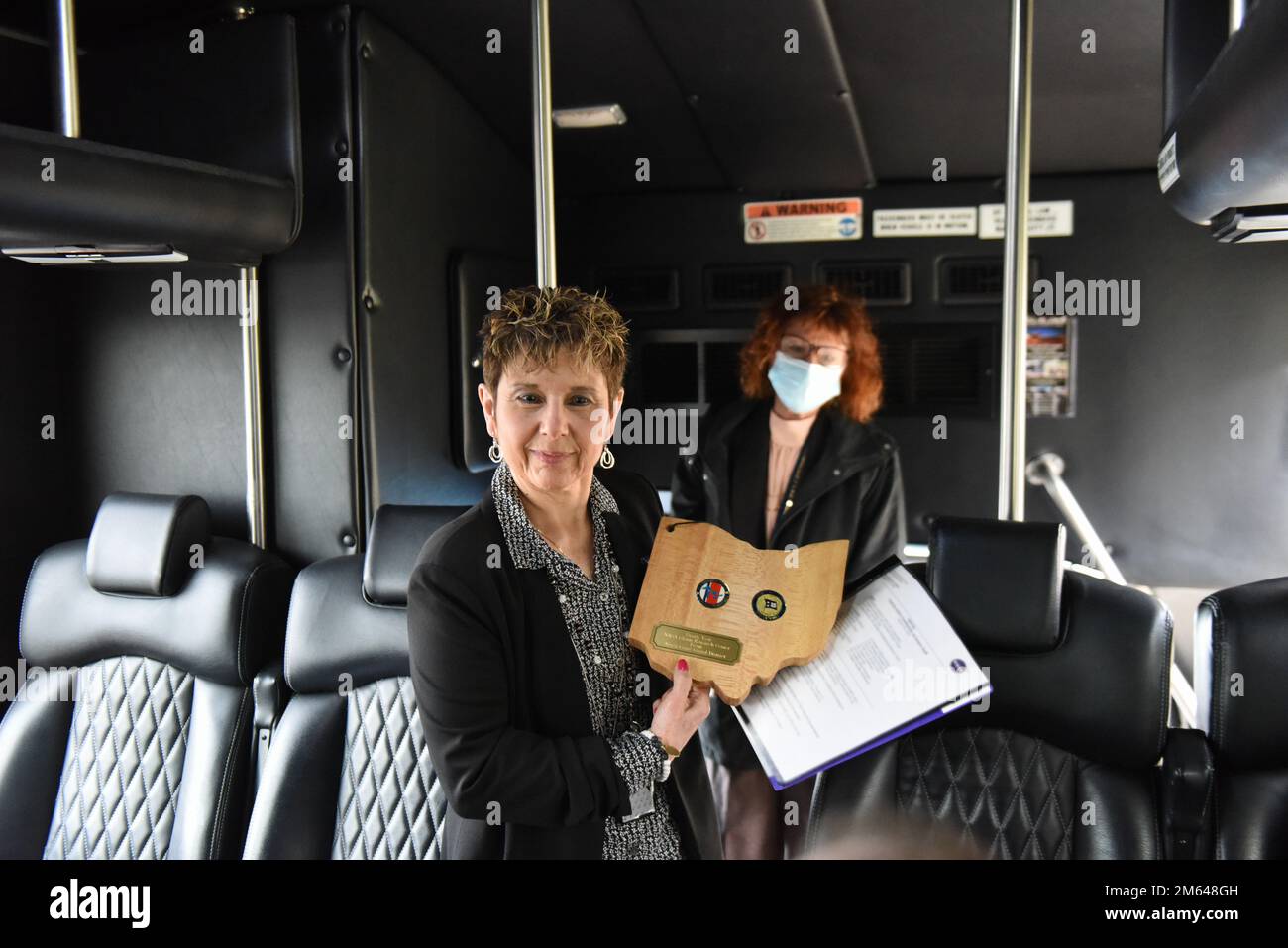 Dr. Marla E. Pérez-Davis, Director of the National Aeronautics and Space Administration's John H. Glenn Research Center, poses for a photo on the tour bus at the NASA Glenn Research Center in Cleveland, Ohio, March 30, 2022. The commander of the U.S. Coast Guard Ninth District presented Dr. Pérez-Davis with a plaque as a token of appreciation for inviting members of the Coast Guard on the tour. Stock Photo