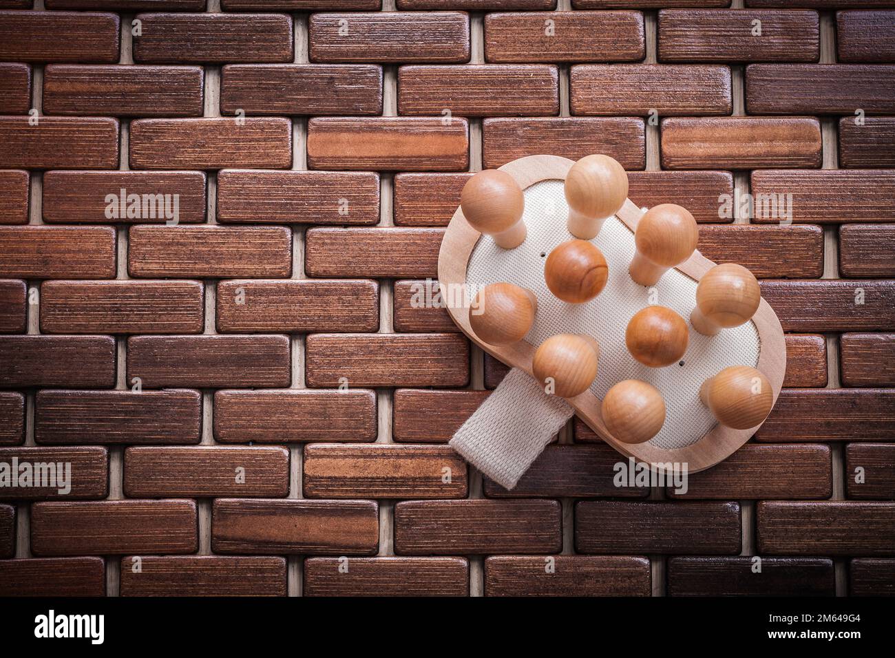 Wood massager on textured wooden mat healthcare concept Stock Photo Alamy