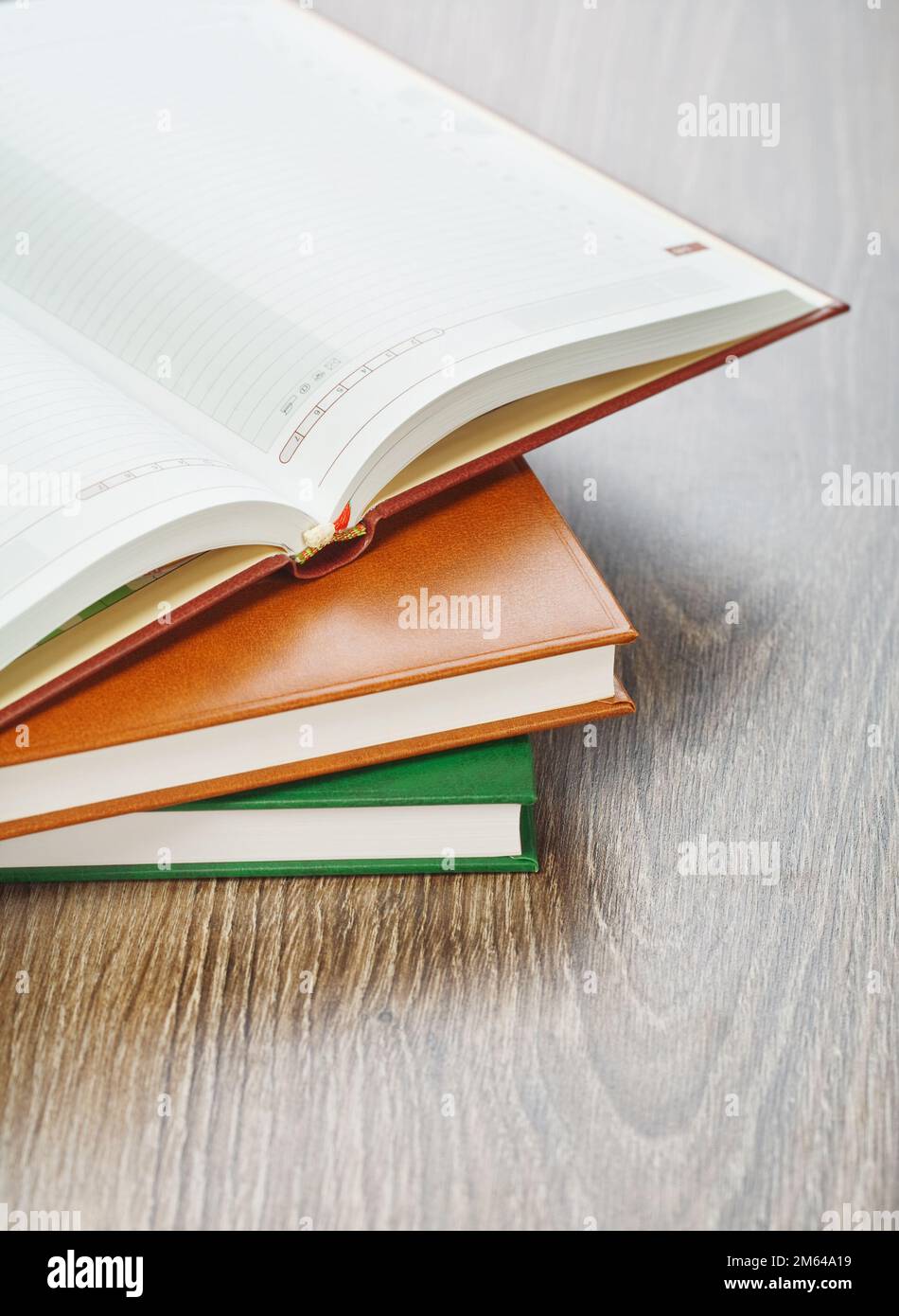three notebooks on wooden background Stock Photo