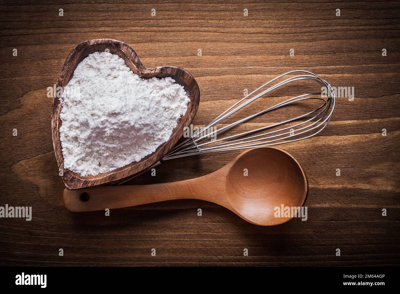 Wooden spoon heartshaped bowl flower egg-whisk food and drink concept ...