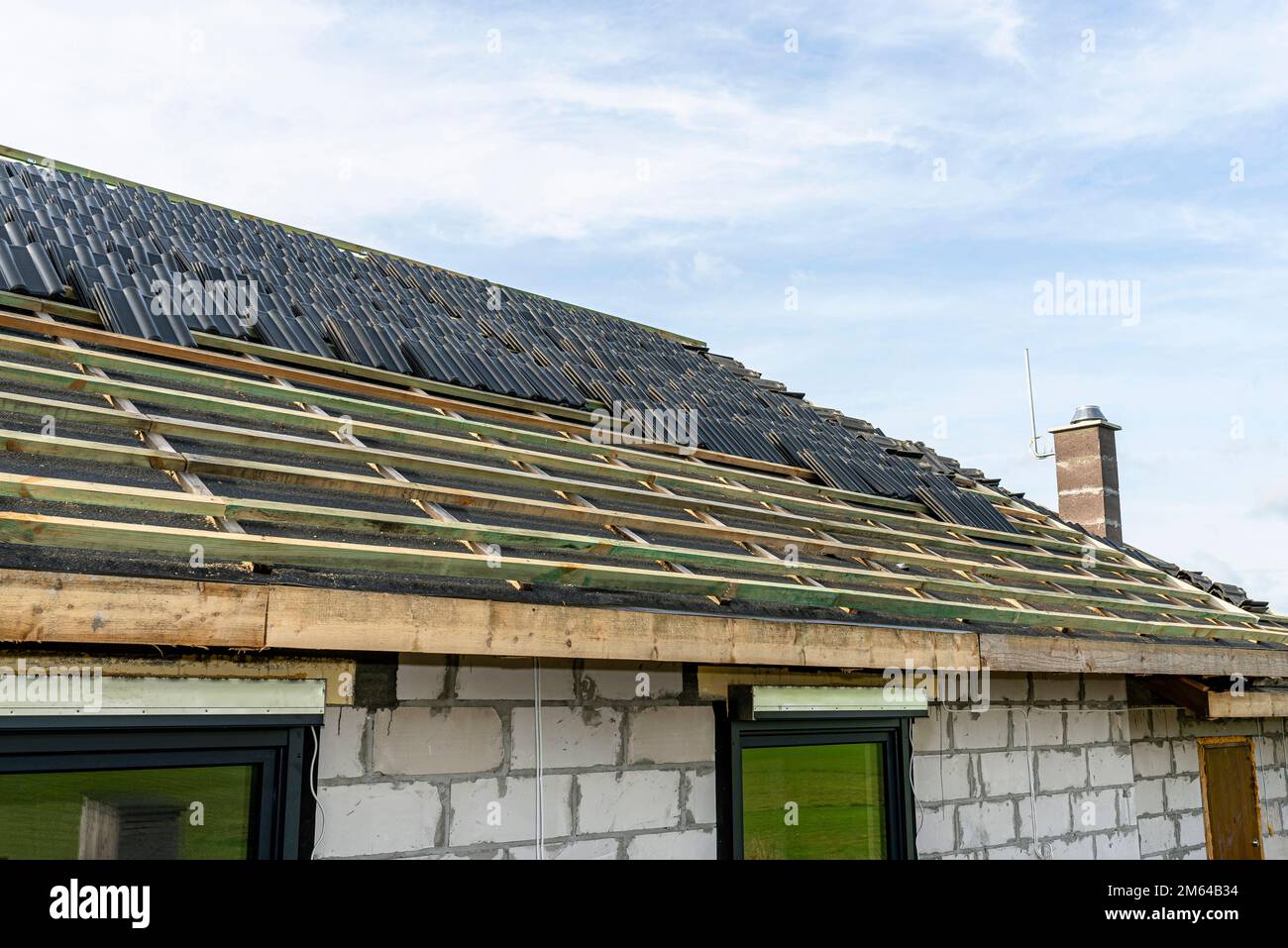 Roof ceramic tile arranged in packets on the roof on roof battens. Preparation for laying tiles
