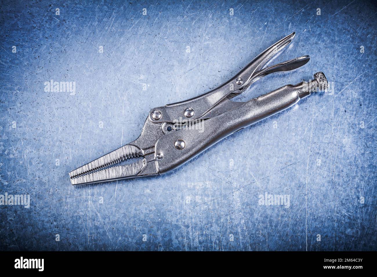 Metal closed lock jaw pliers on metallic background Stock Photo Alamy
