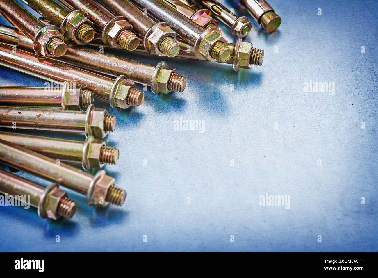 Variation of metal anchor bolts with construction nuts on metallic