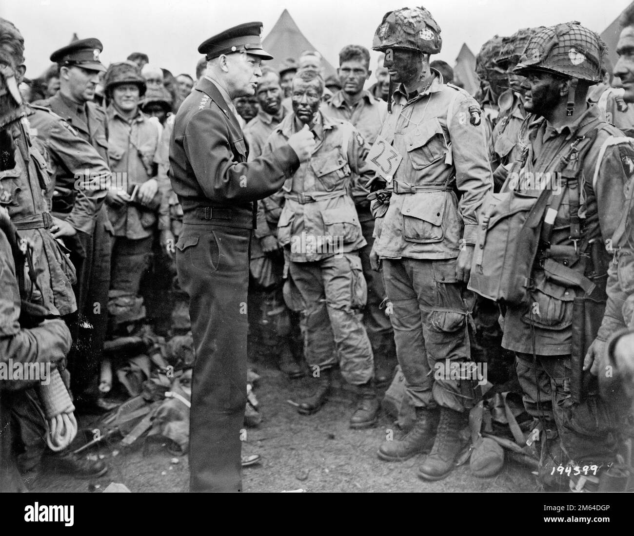 General Dwight D. Eisenhower addresses American paratroopers prior to D-Day. 'Gen. Dwight D. Eisenhower gives the order of the Day. 'Full victory-nothing less' to paratroopers in England, just before they board their airplanes to participate in the first assault in the invasion of the continent of Europe.' Eisenhower is meeting with US Co. E, 502nd Parachute Infantry Regiment (Strike) of the 101st Airborne Division, photo taken at Greenham Common Airfield in England about 8:30 p.m. on June 5, 1944. U.S. Army photograph. Stock Photo