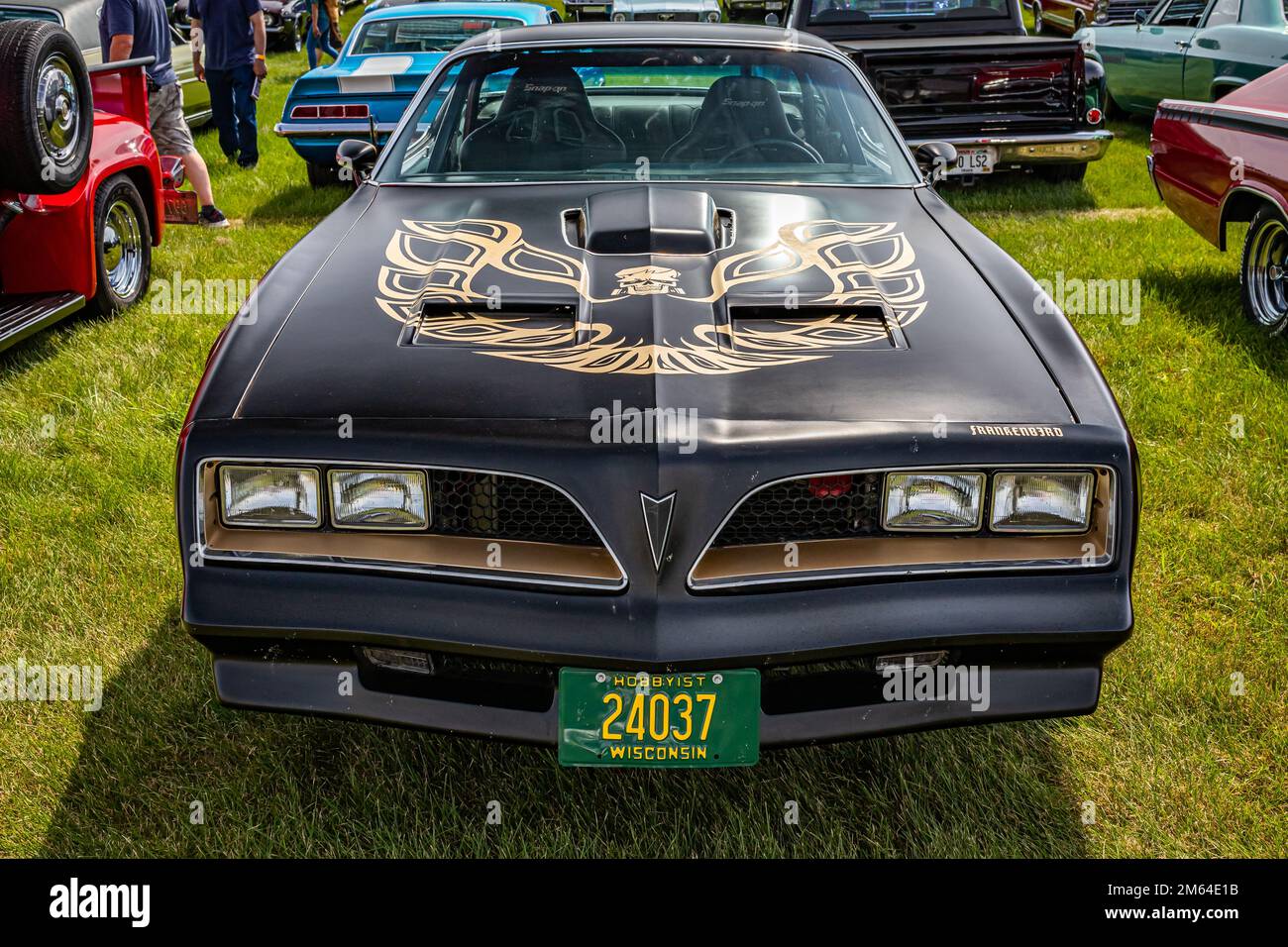 Iola, WI - July 07, 2022: High perspective front view of a 1977 Pontiac Firebird Trans Am at a local car show. Stock Photo