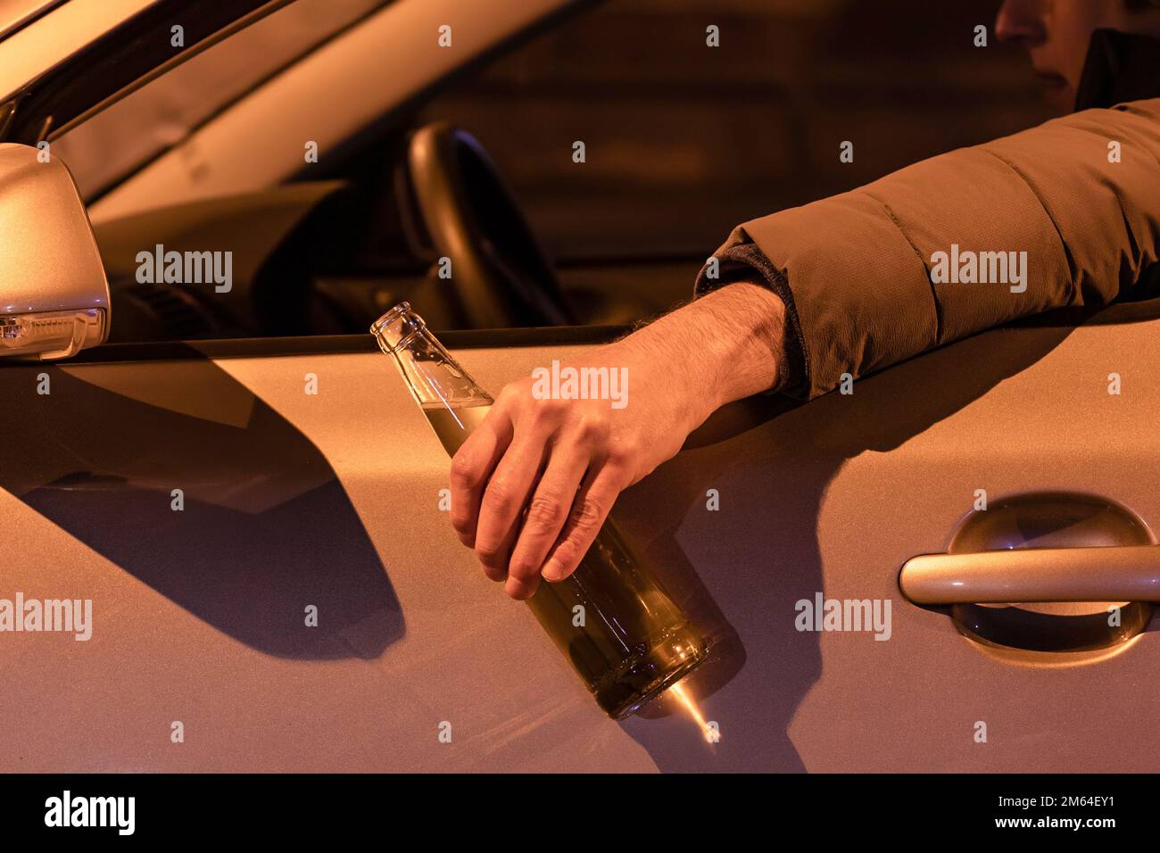 Drunk Man Driving A Car With A Bottle Of Beer At The Night Don T Drink And Drive Concept Stock Photo Alamy