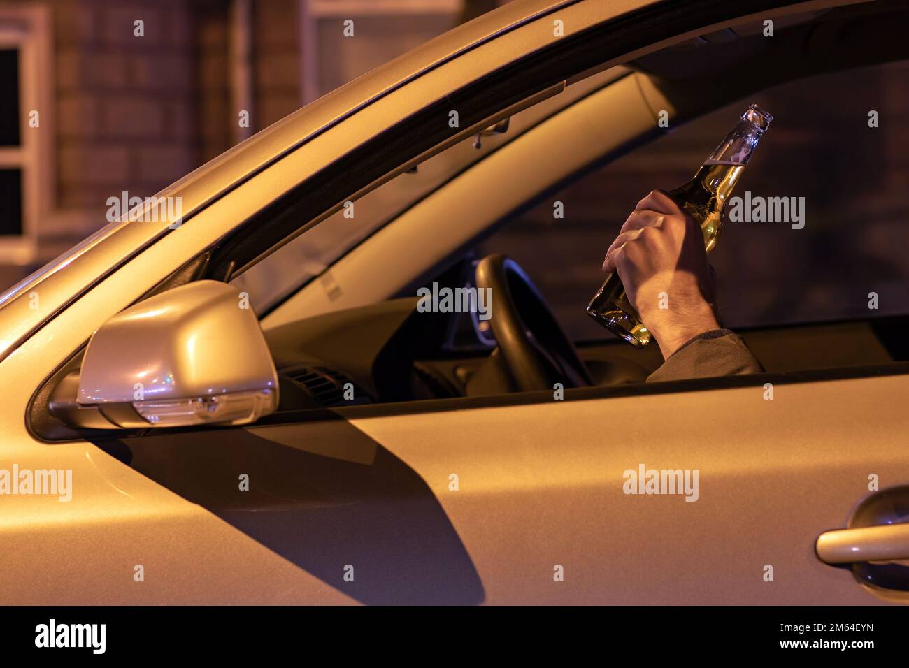 Drunk Man Driving A Car With A Bottle Of Beer At The Night Don T Drink And Drive Concept Stock Photo Alamy