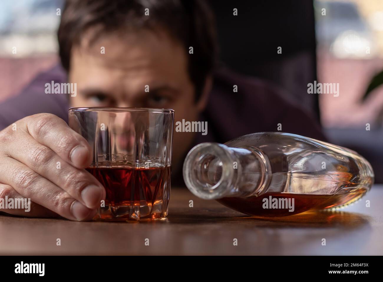 Alcoholism concept. Businessman drinking alcohol afterhours Stock Photo