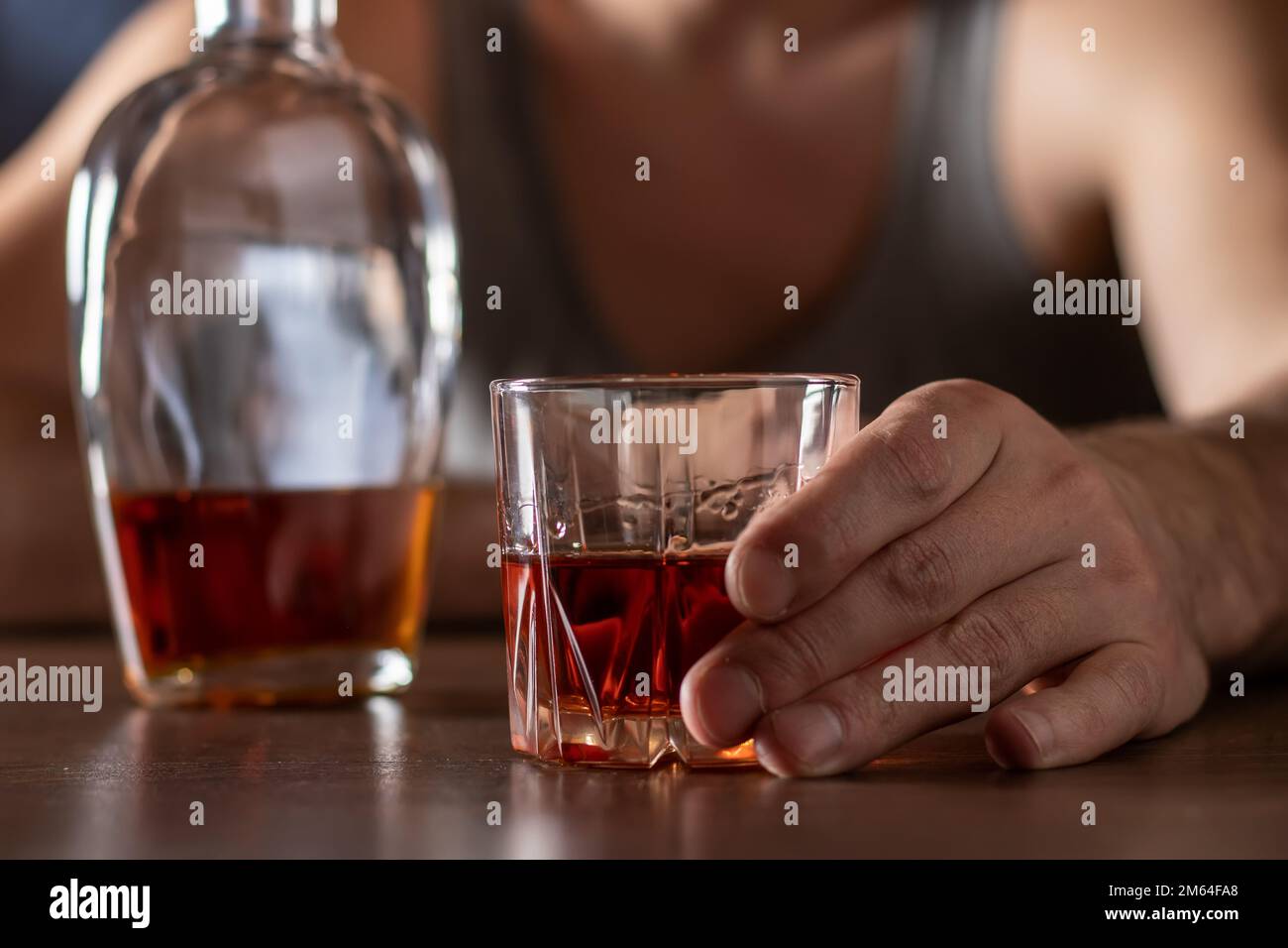 Alcoholism concept. Young man drinking alcohol too much. Alcoholic in a