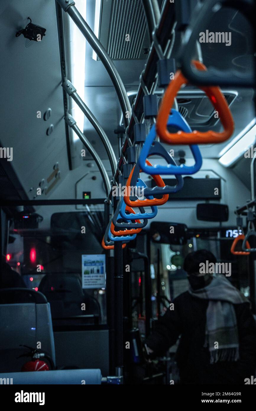 A vertical shot of the colorful handrails in the bus Stock Photo - Alamy